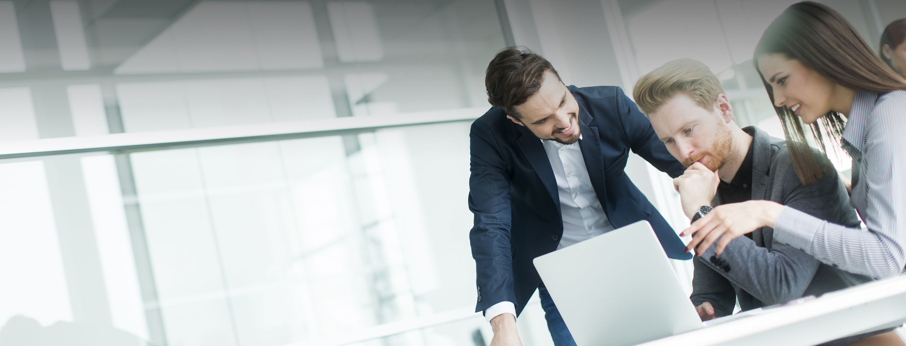 2880x1100 of a group of young people working in the modern office
