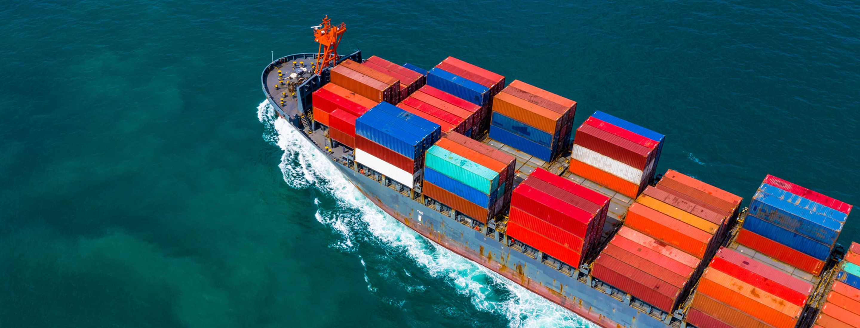 Cropped 2880x1100 container ship carrying container for import and export, Aerial view business logistic and freight transportation by ship in open sea.