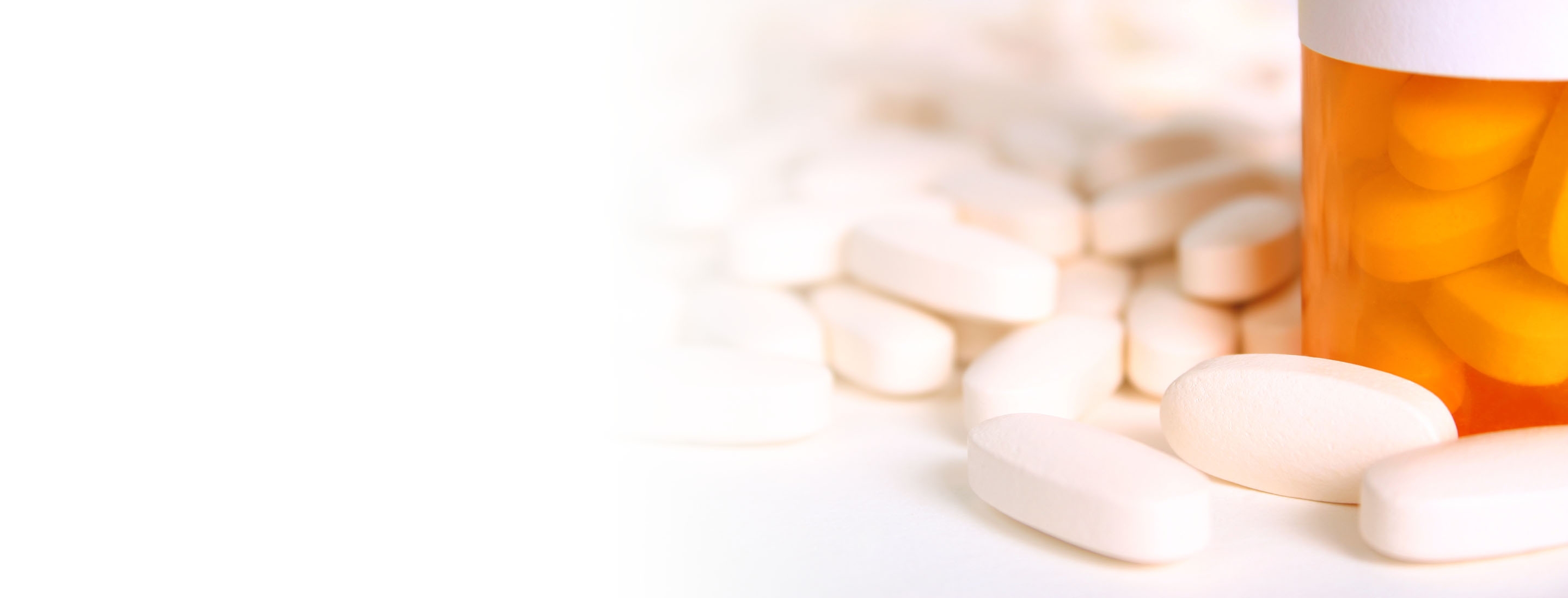 2880x1100 left white gradient of pile of pills with a prescription bottle