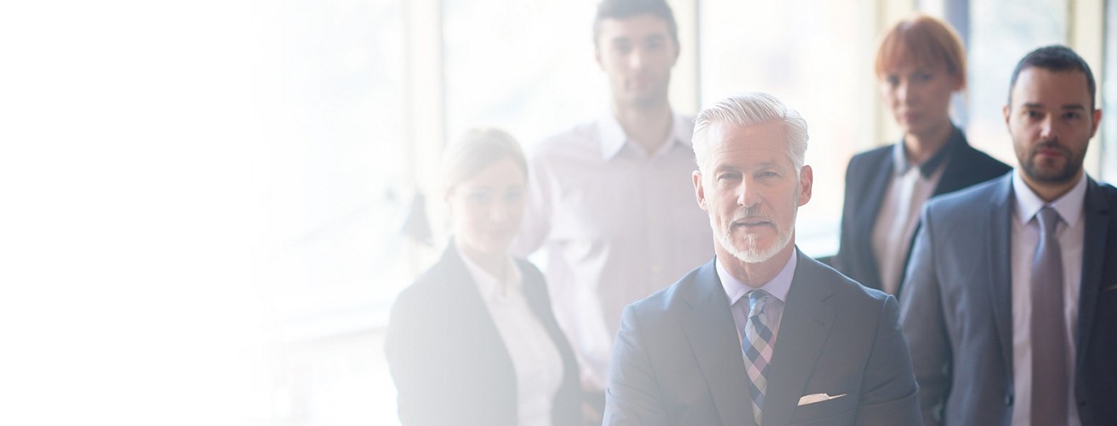 Cropped 2880x1100 left white gradient of senior businessman with his team at office. business people group