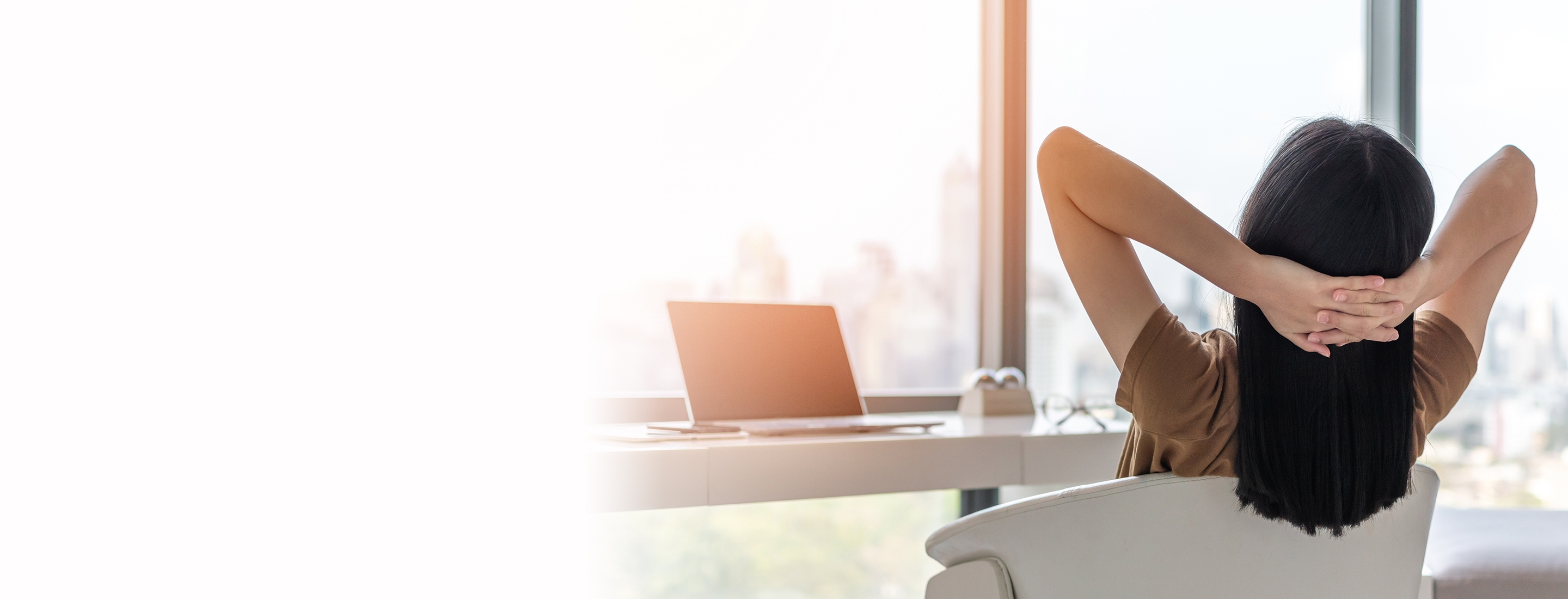 woman kicks back at her desk to enjoy a mental health break at work
