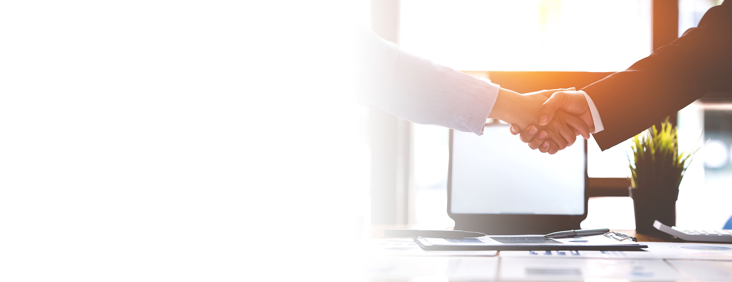 An employer shaking hands with a newly hired at-will employee.