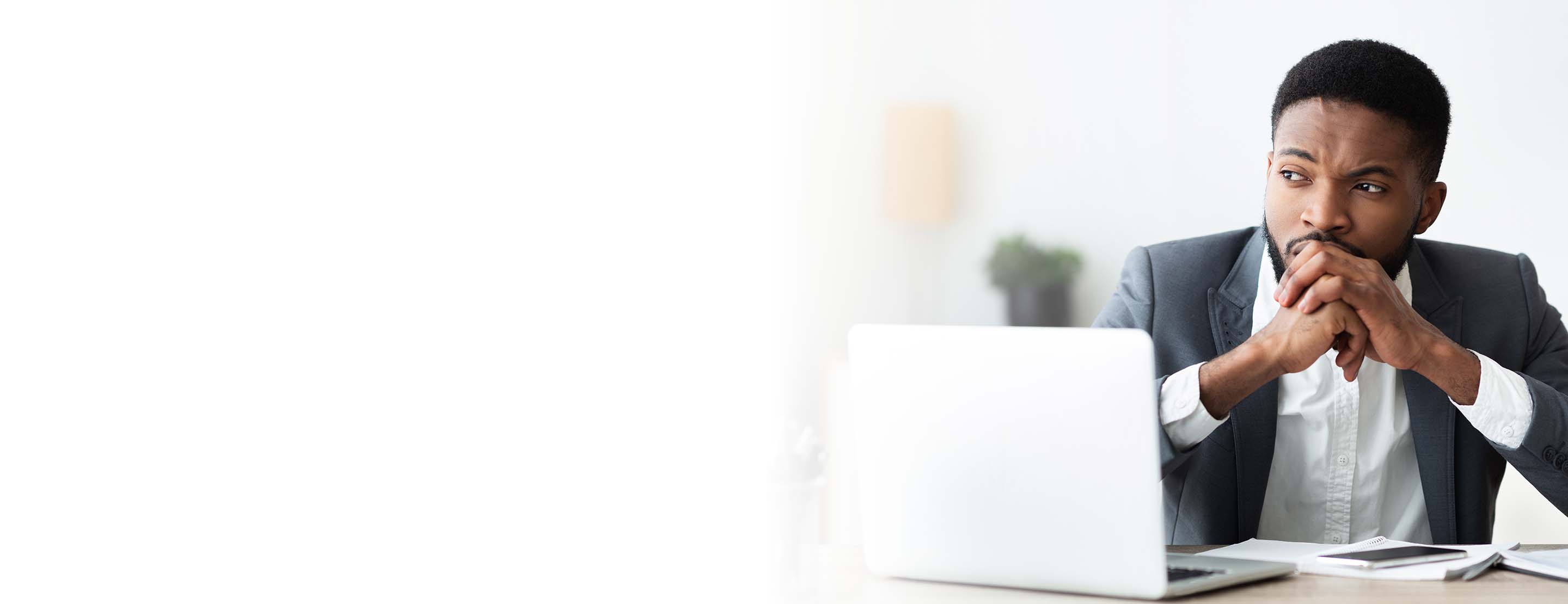 A man sitting at his desk worrying about workplace discrimination.