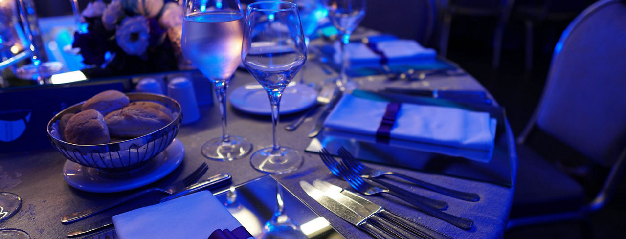 2880x1100 of a wedding hall or other function facility set for fine dining