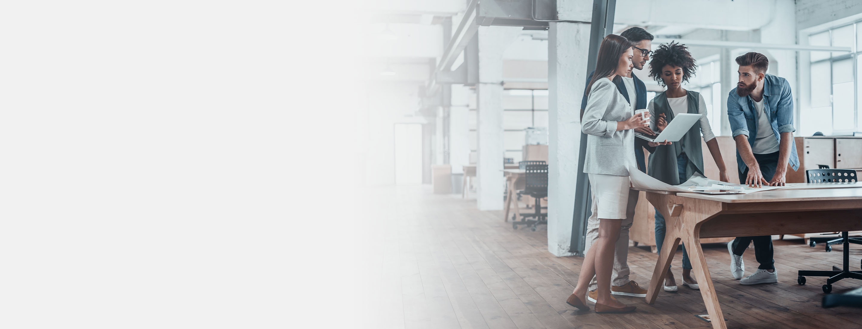 2880x1100 left gray gradient of a group of young business people working together in creative office while standing near the wooden desk 