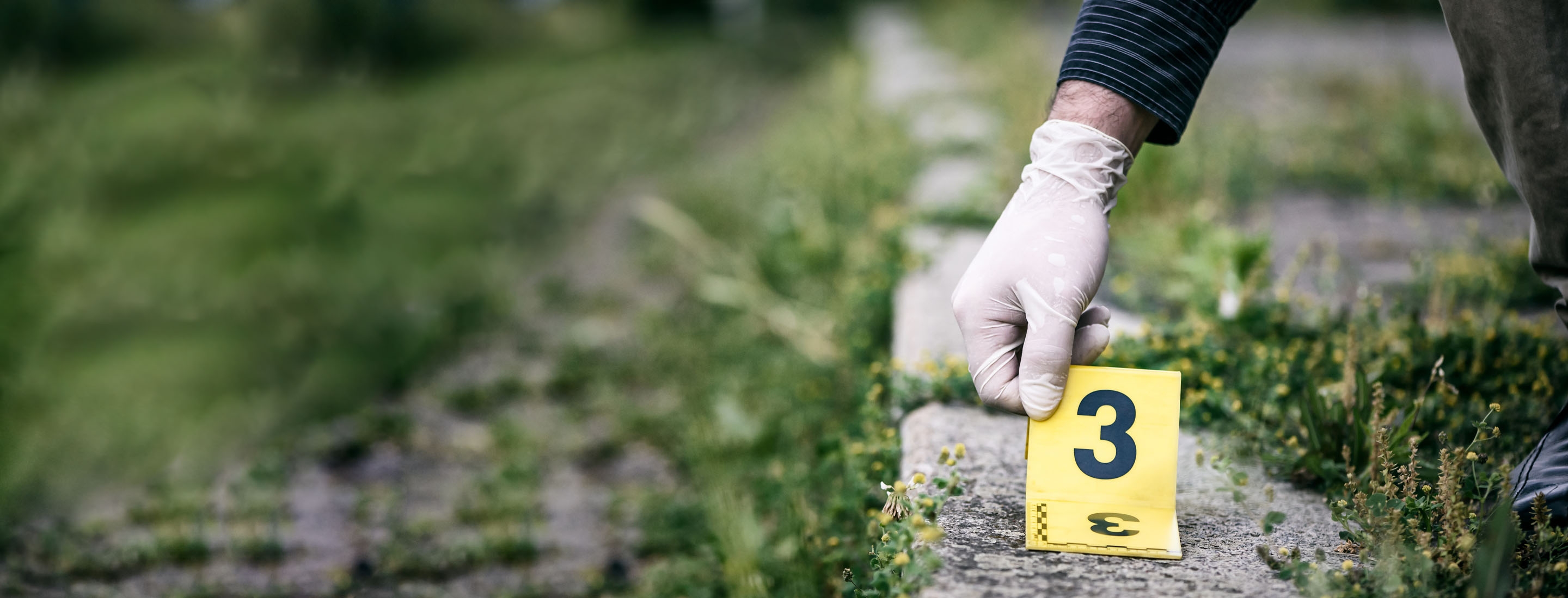 2880x1100 of placing the crime scene marker on the ground near train track