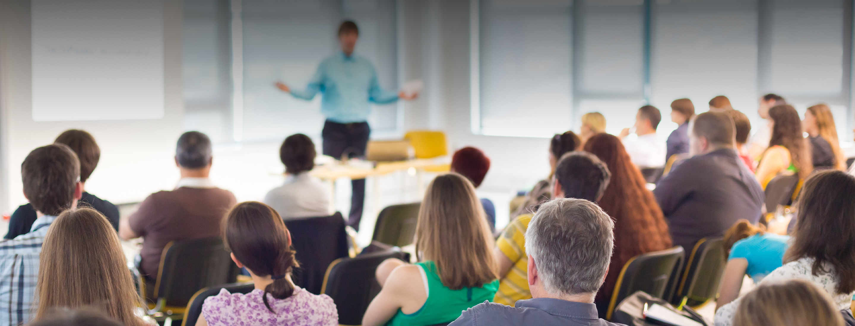Speaker at business workshop and presentation. Audience at the conference room.
