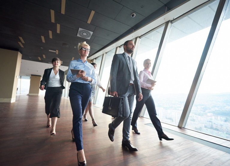 businesspeople  group walking at modern bright office interior