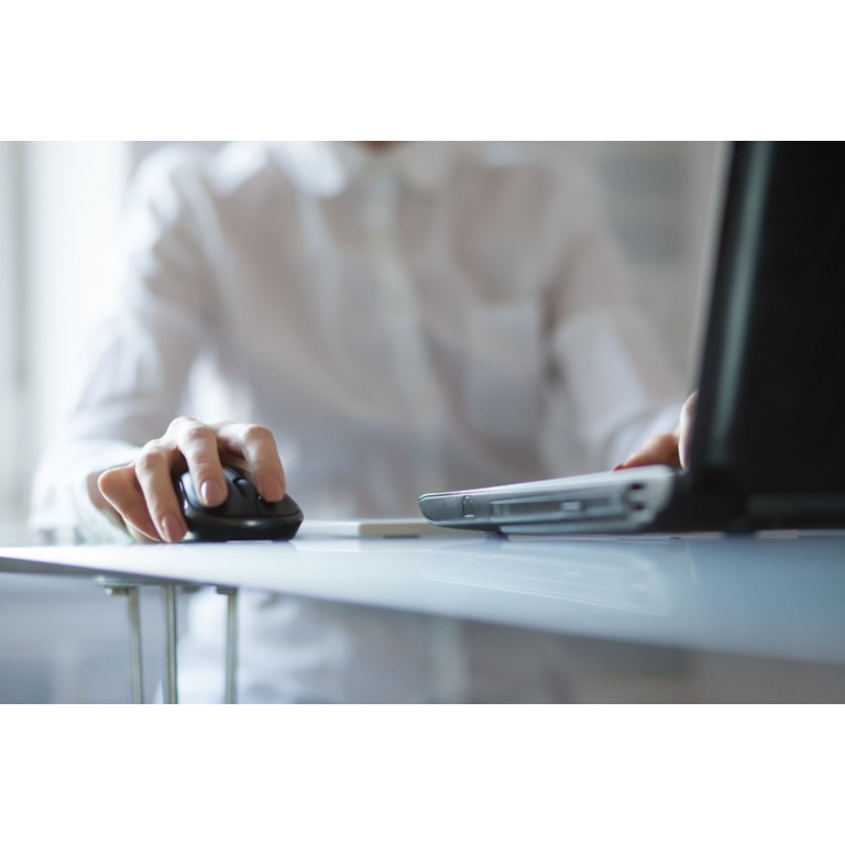 womans-hand-using-cordless-mouse-glass-table