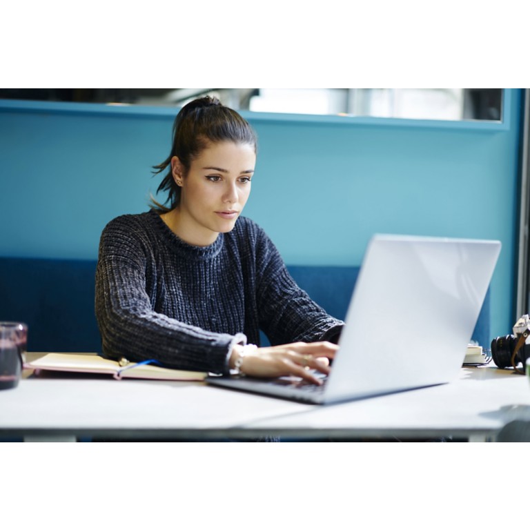 female-remote-job-coworking-office-typing-laptop