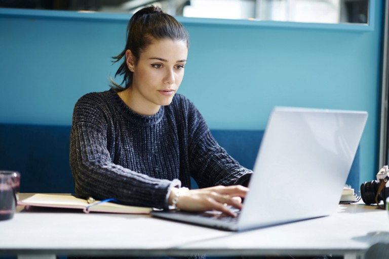 female-remote-job-coworking-office-typing-laptop
