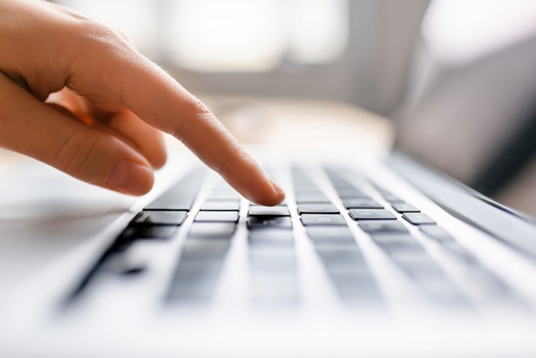 finger-press-button-laptop-keyboard