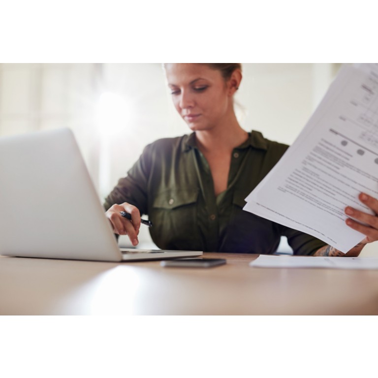 woman-table-documents-working-laptop