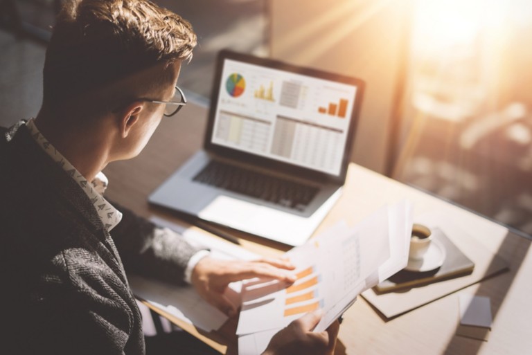 businessman-analyze-document-graphs-diagram-notebook-screen