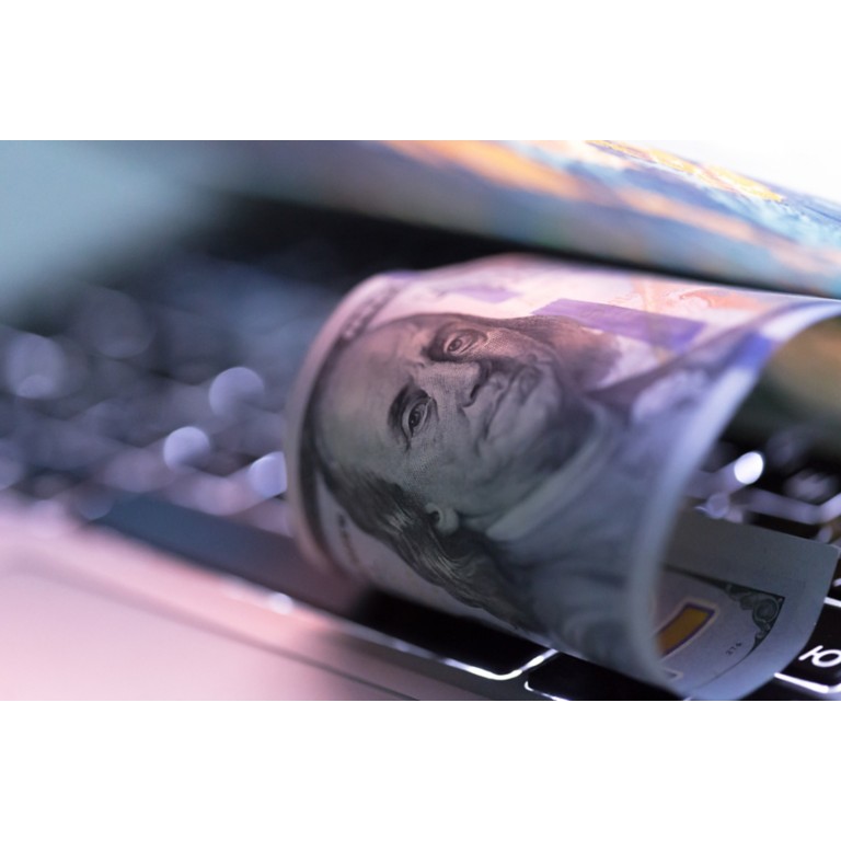 100-dollar-rolled-bill-laptop