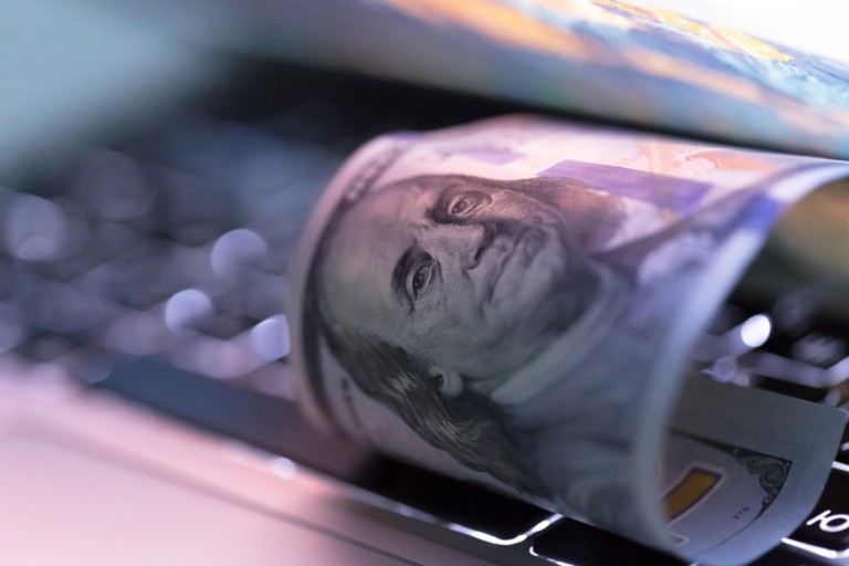 100-dollar-rolled-bill-laptop
