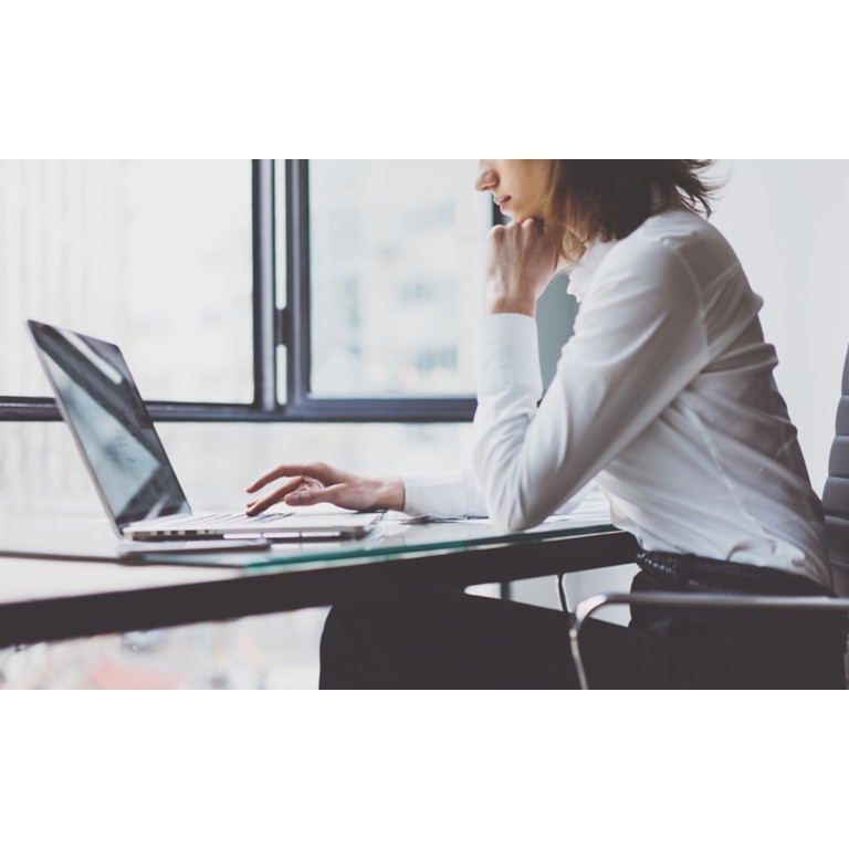 modern-office-woman-wood table-typing-keyboard-laptop