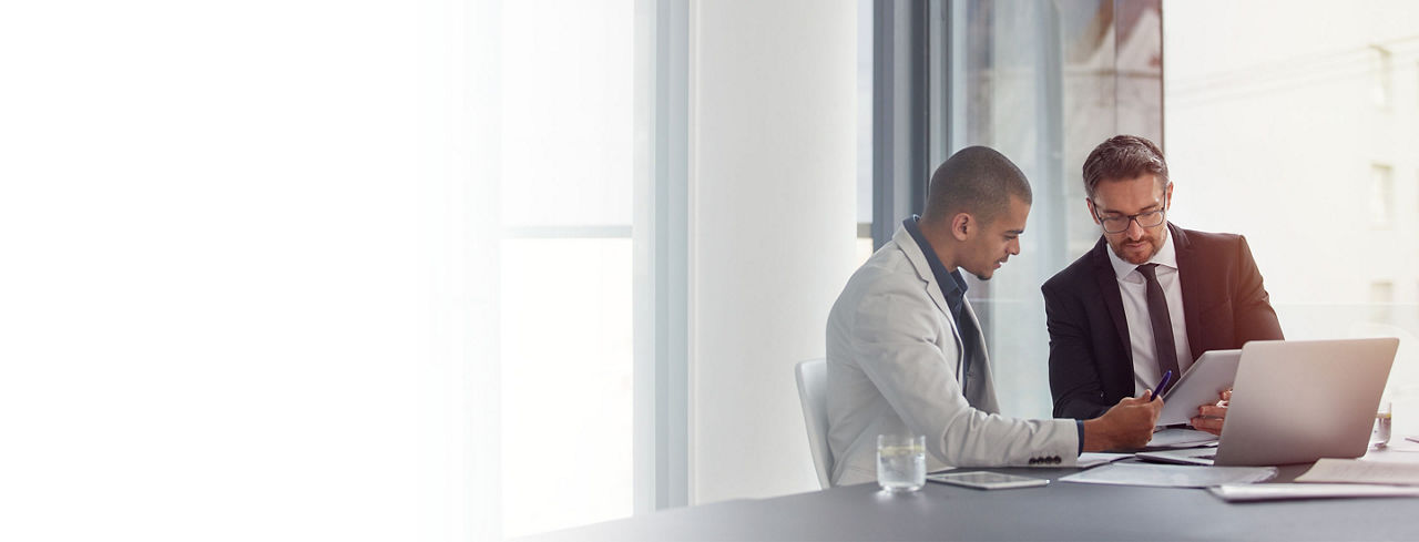 2880x1100 left white gradient of two businessmen having an office meeting