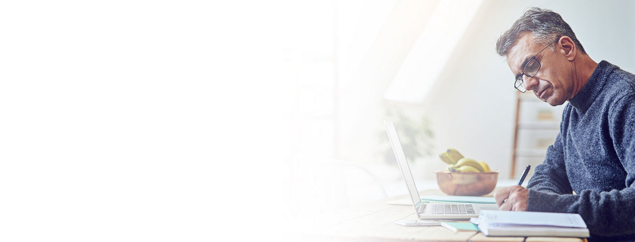 2880x1100 flipped horizontal left white gradient of a senior man using a laptop at home