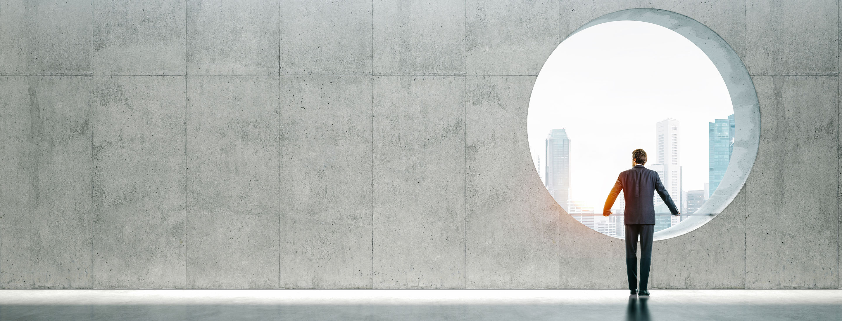 2880x1100 of blank space interior with view on the city and young businessman wearing modern suit