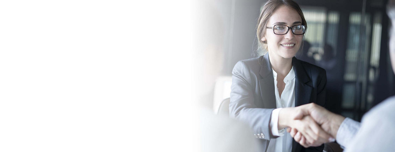 An FLSA exempt employee shaking hands with clients.