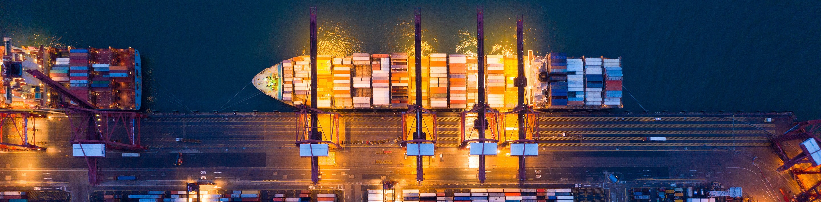 An overhead view of a docked container ship.